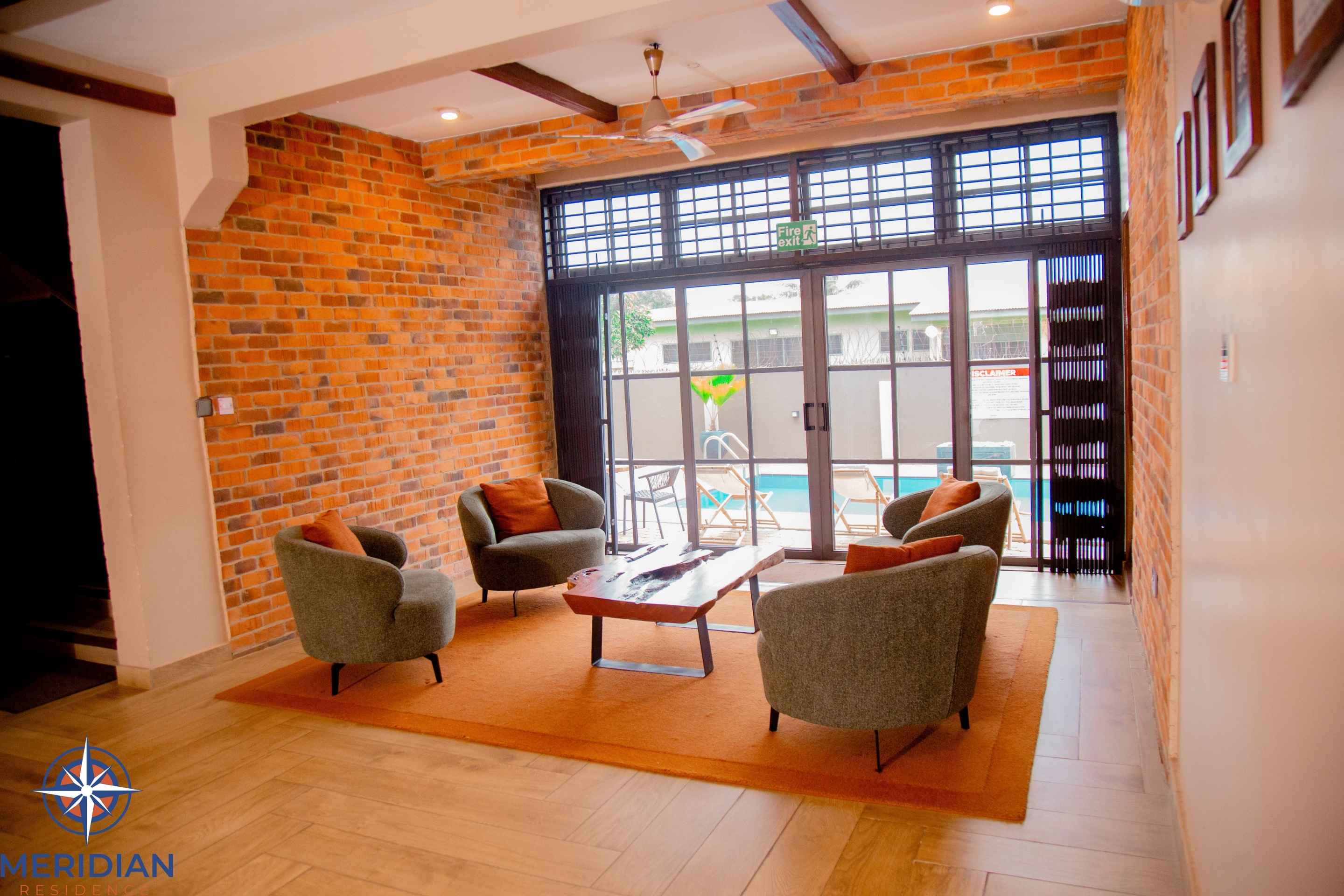Lounge seating with view of the pool at Meridian Residence, Tema