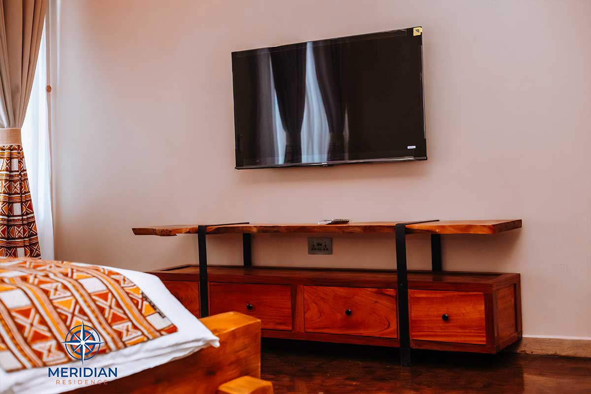 In-room smart TV and dresser at Meridian Residence, Tema